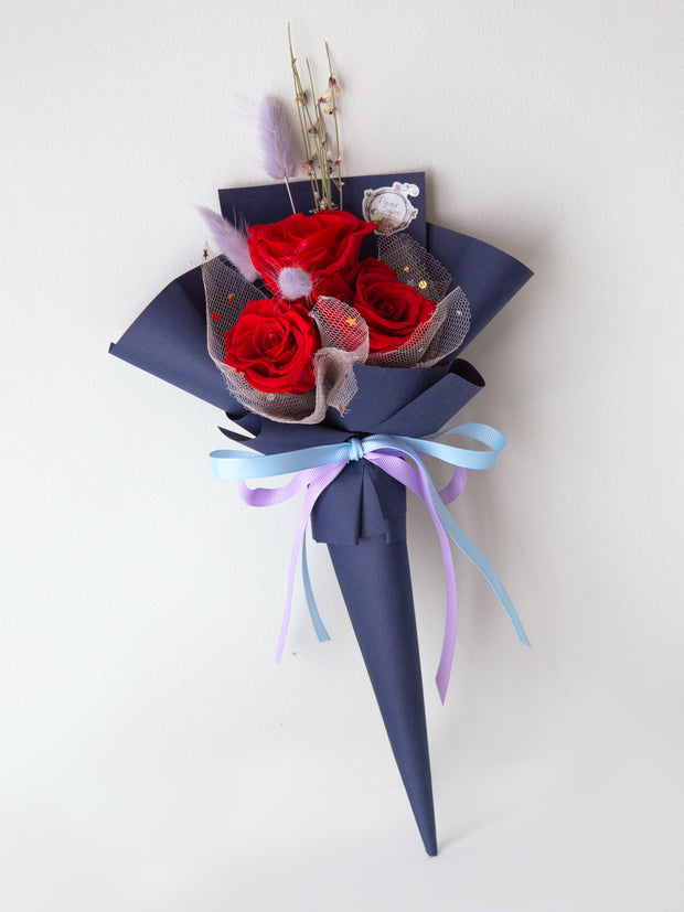 Cone shaped red roses bouquet in navy blue paper 