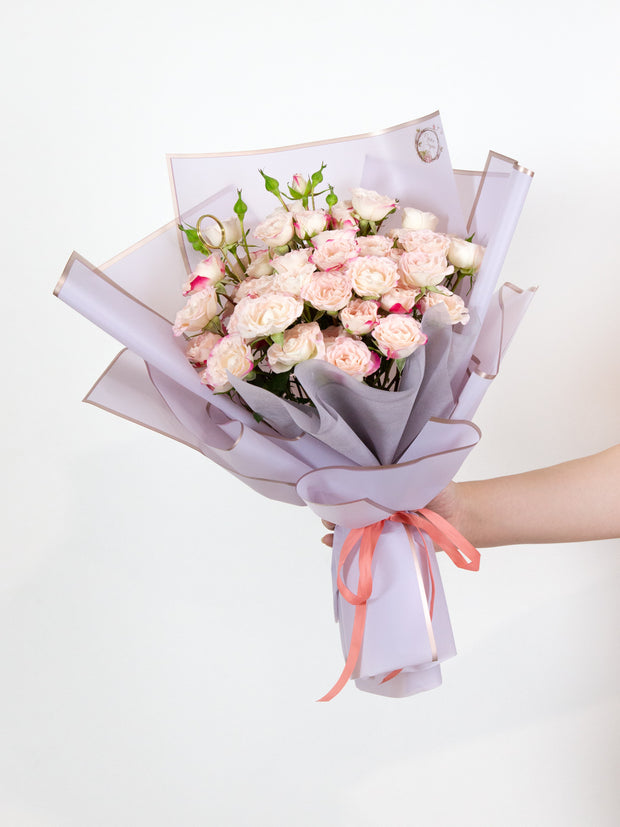 White spray roses with pinkish red tips bouquet
