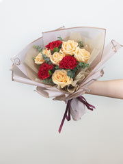 champagne roses and red carnation bouquet