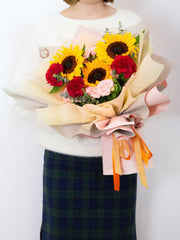 sunflowers, carnations, and roses in one bouquet